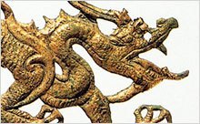 Detail of a cast, gilded dragon plaque.