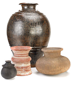 An arrangement of four ceramic vessels of various shapes, sizes, colors, and styles.
