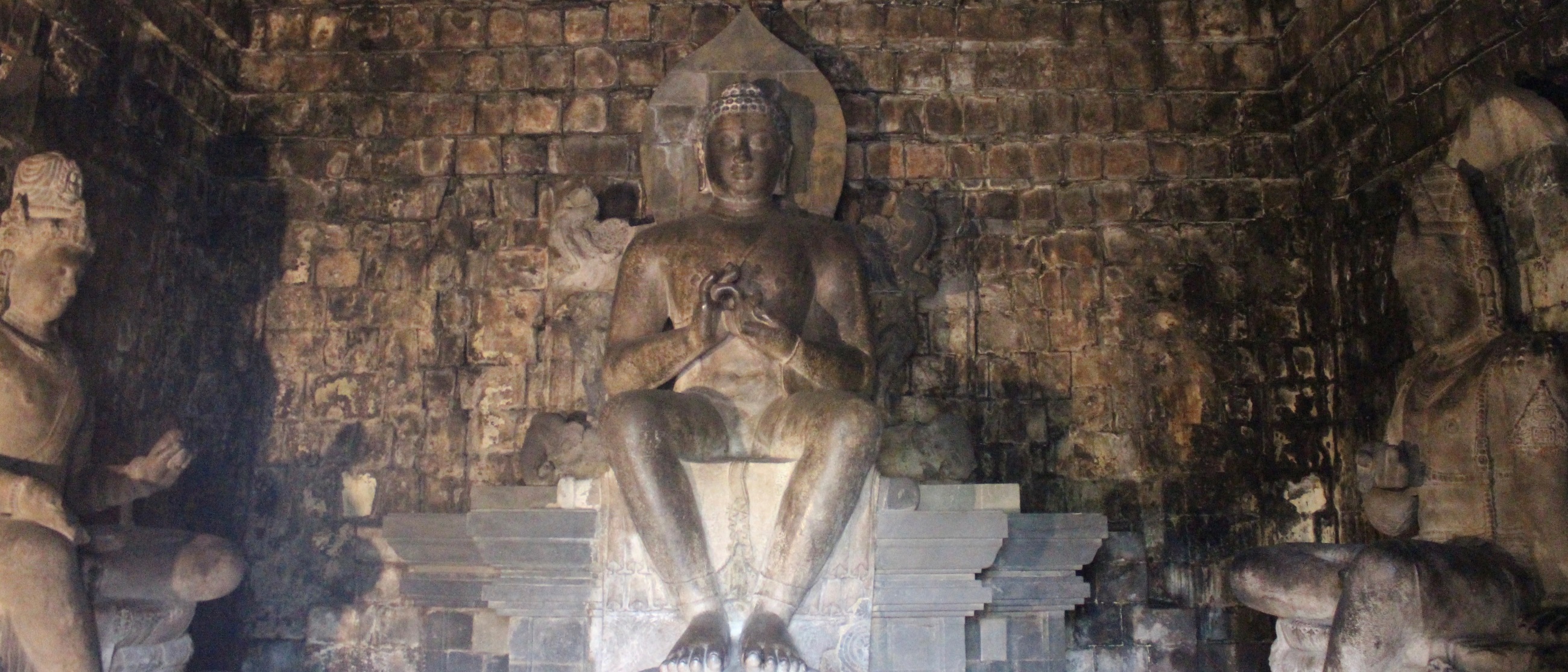 Sanctum contains three massive seated Buddhist figures