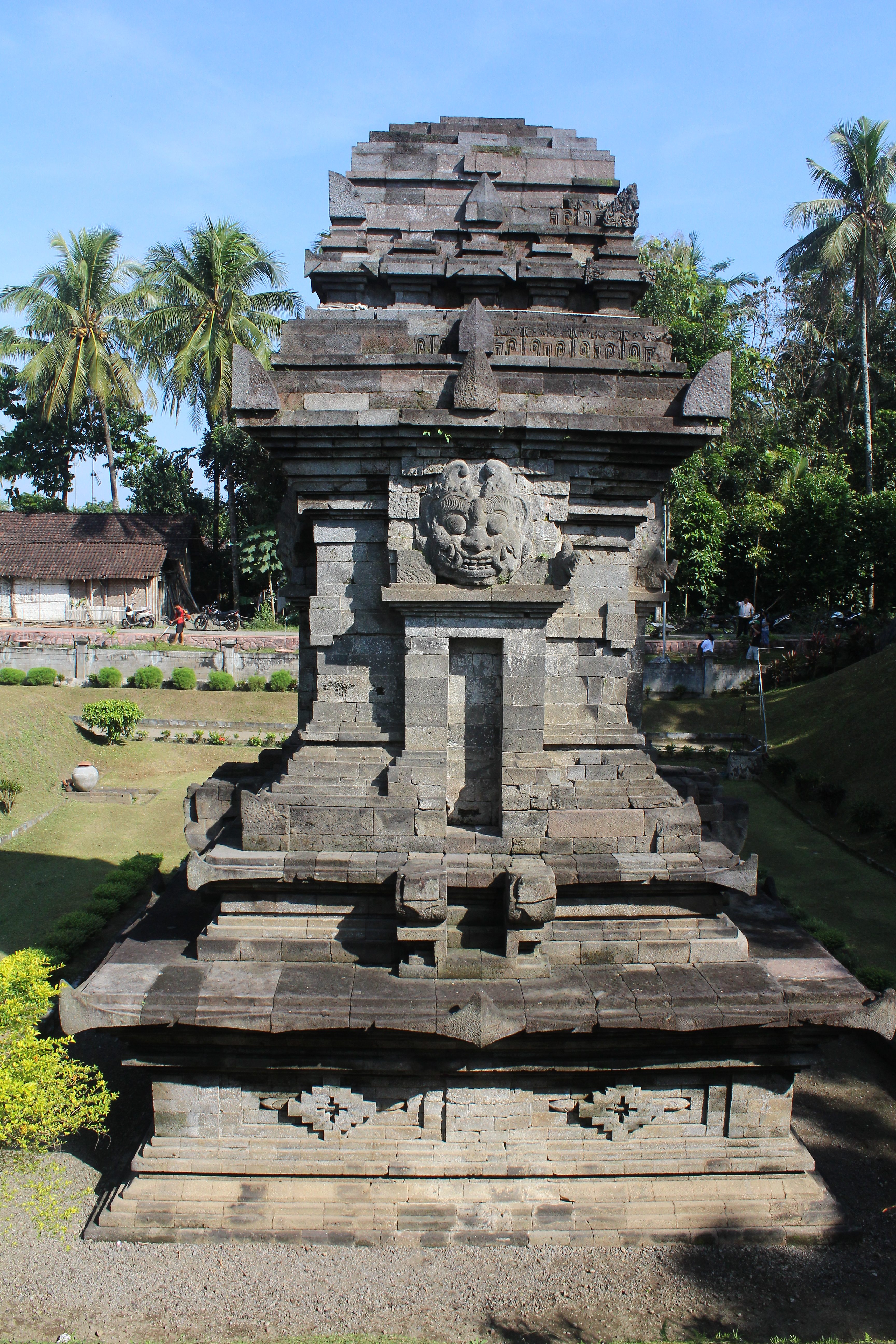 Single-unit stone temple with demon face over a niche