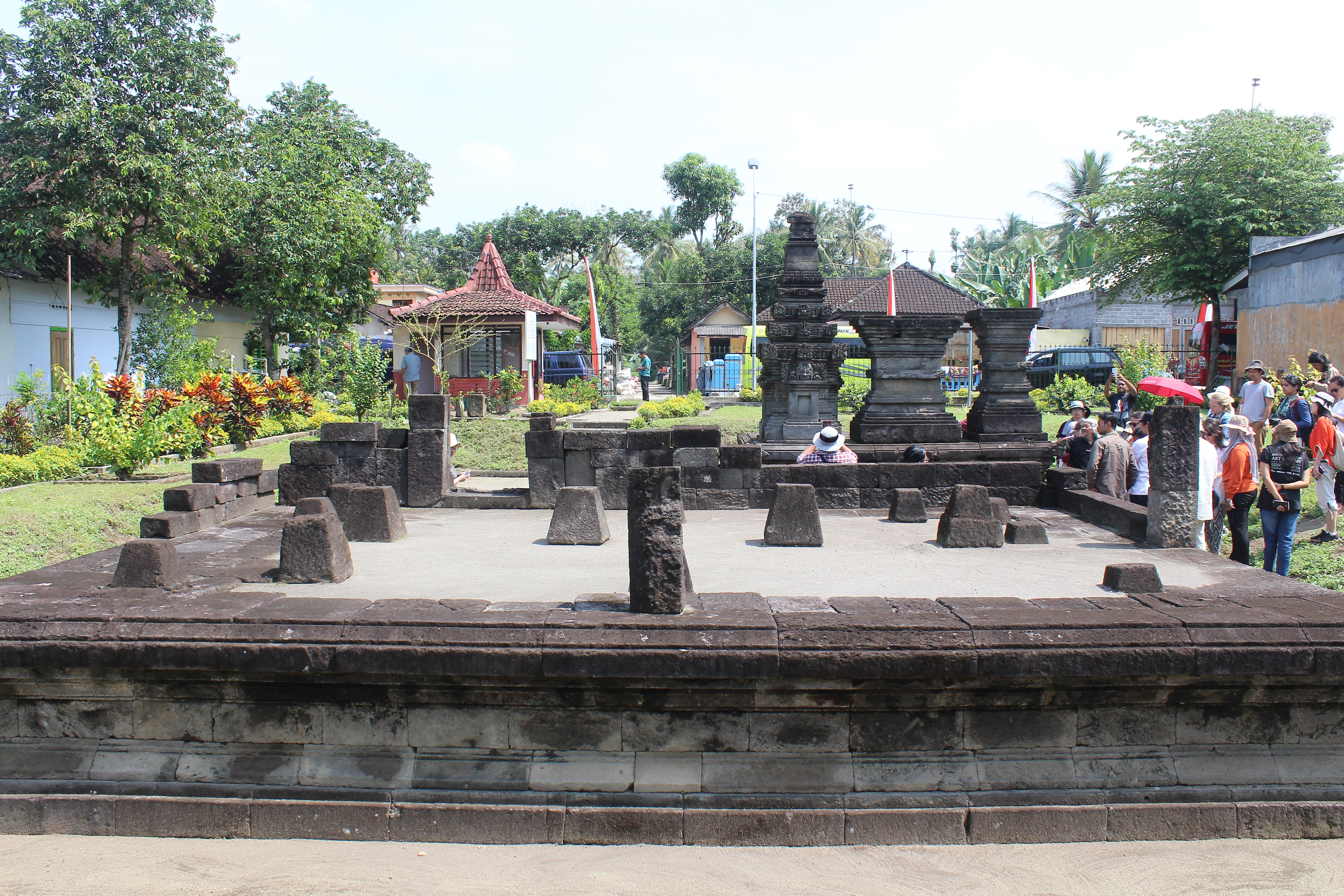 Sparsely remaining temple with cluster of people to the right