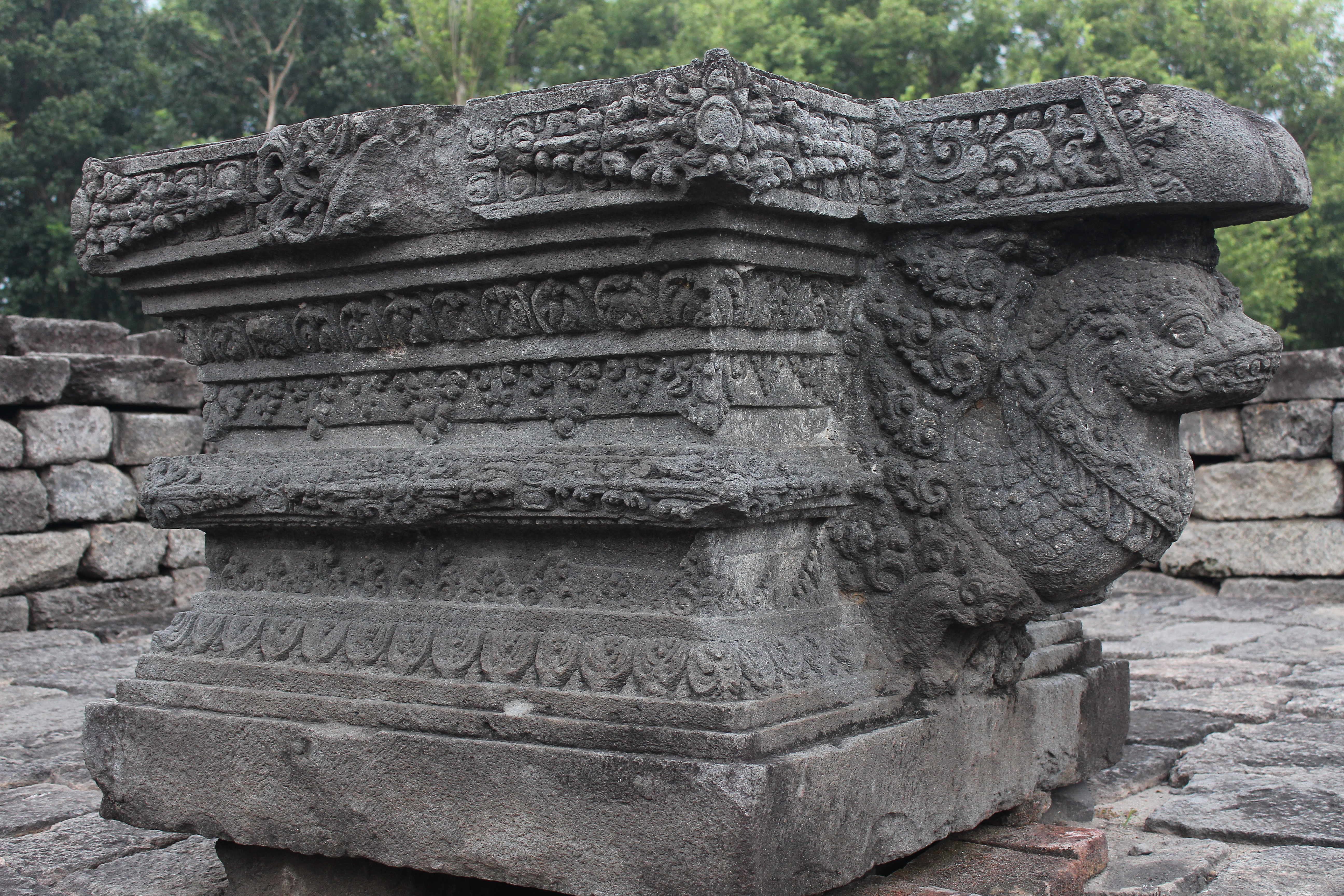 Elaborately carved stone linga pedestal supported by a serpent