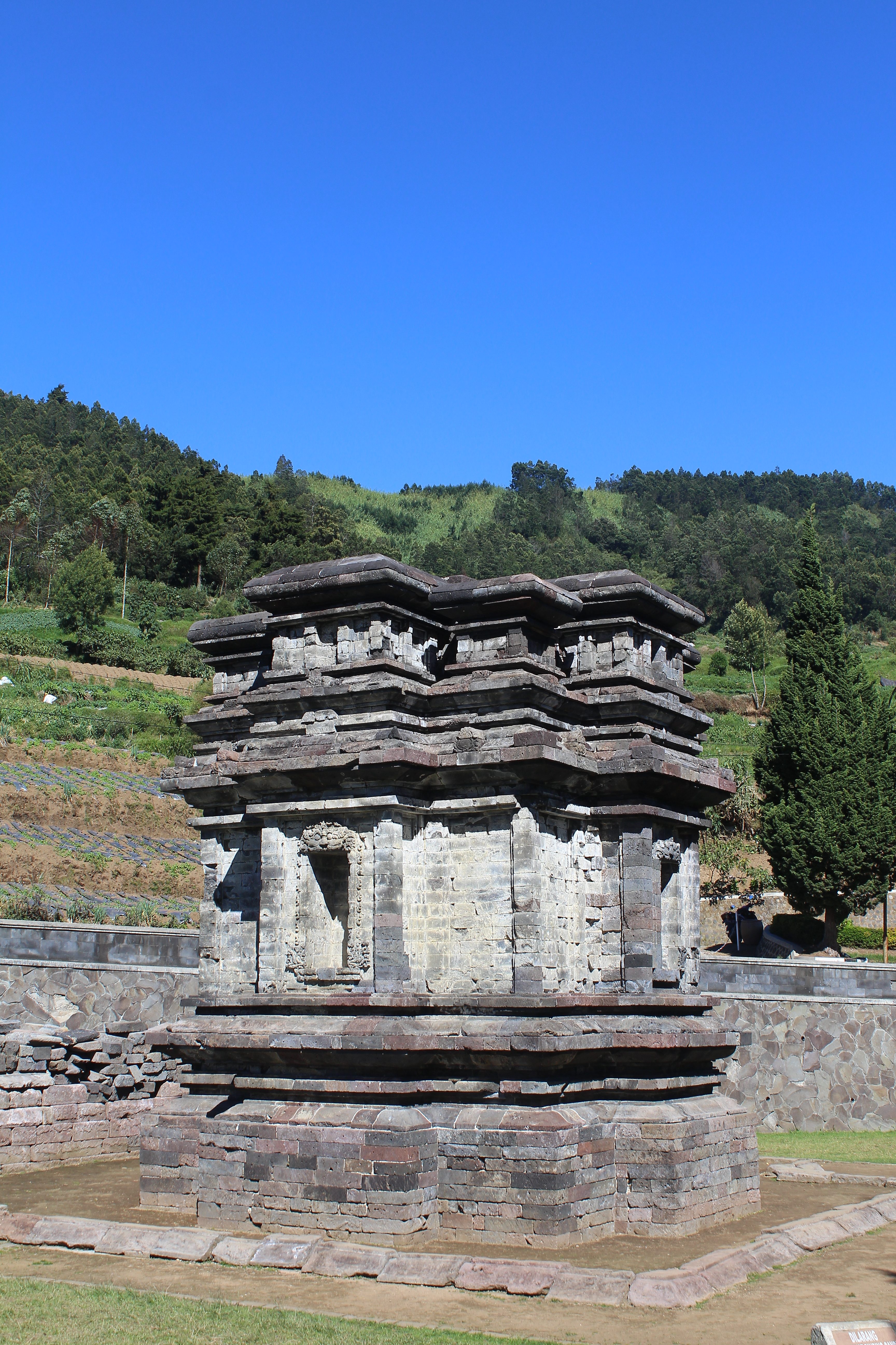 Flat shrine with green hills behind