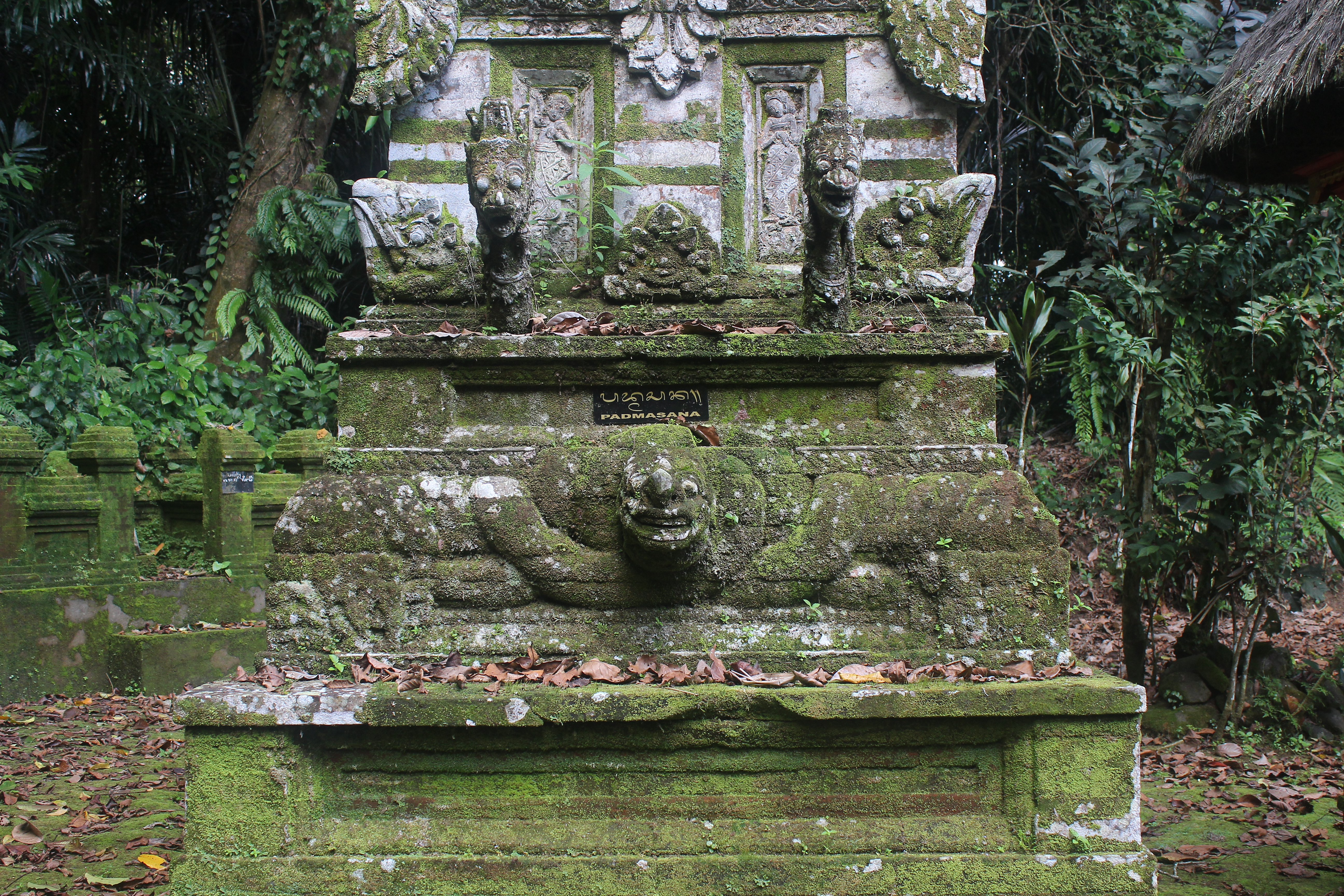 Overgrown shrine with serpent carvings