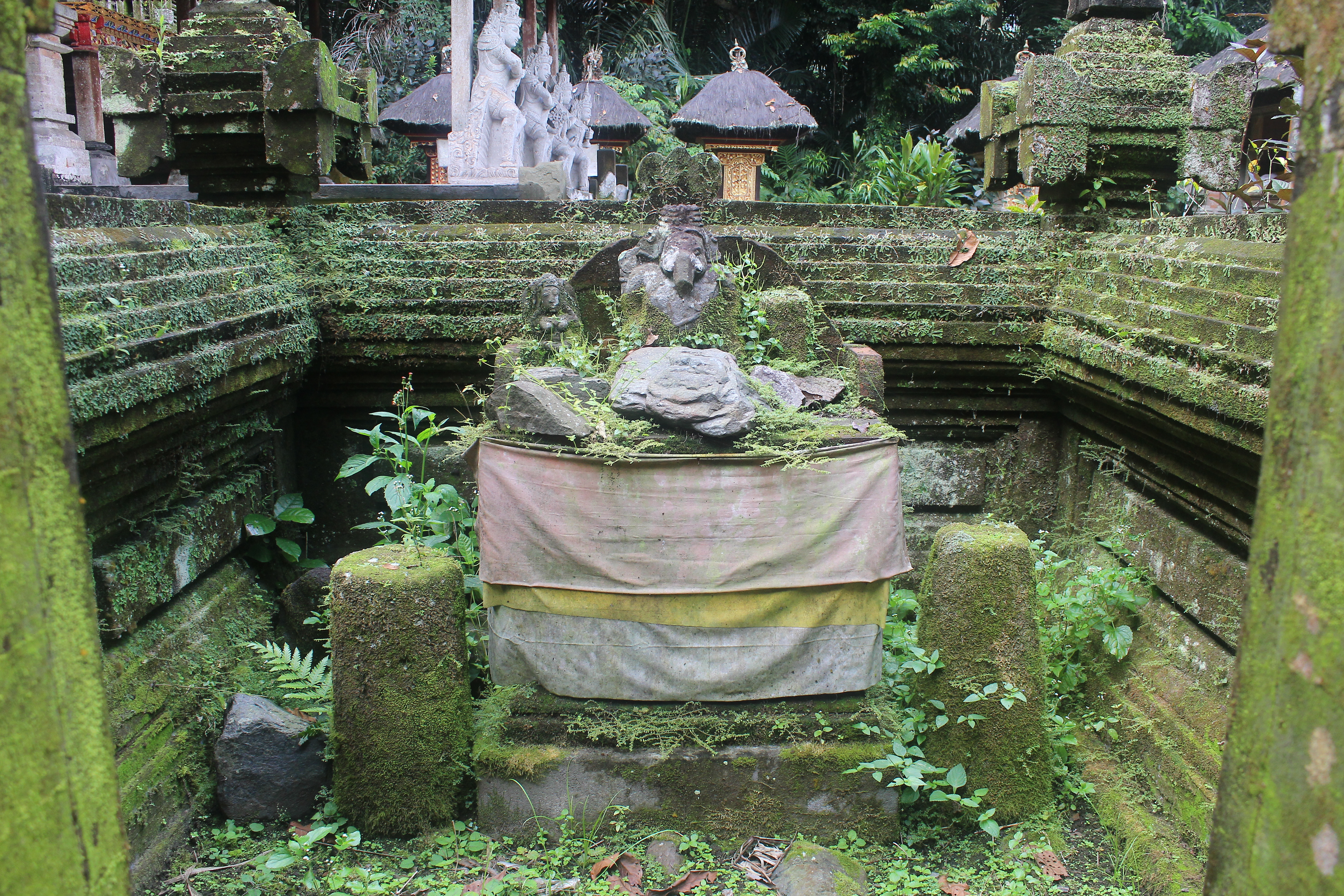 Overgrown low shrine with Ganesha
