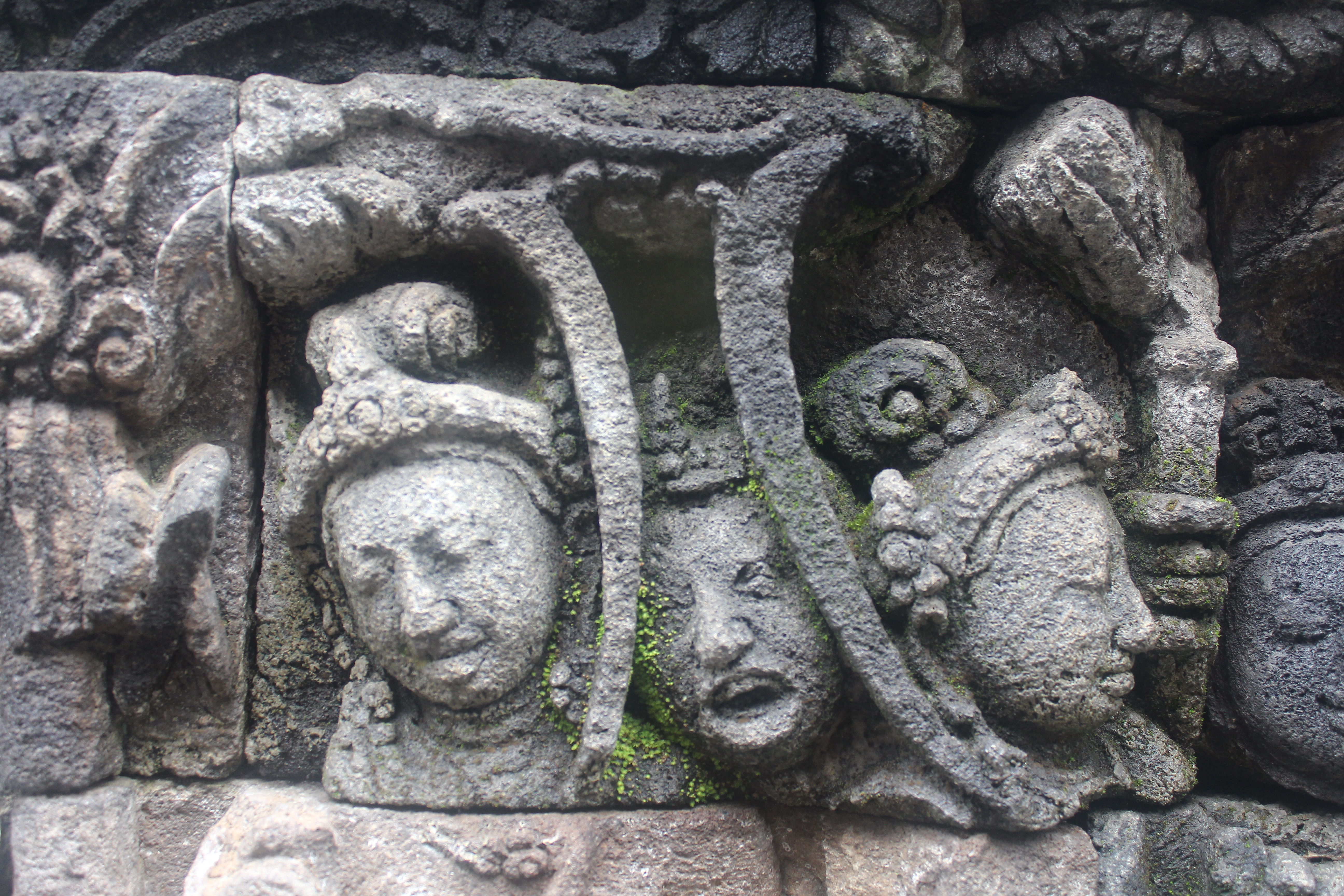 Close up of relief showing three faces