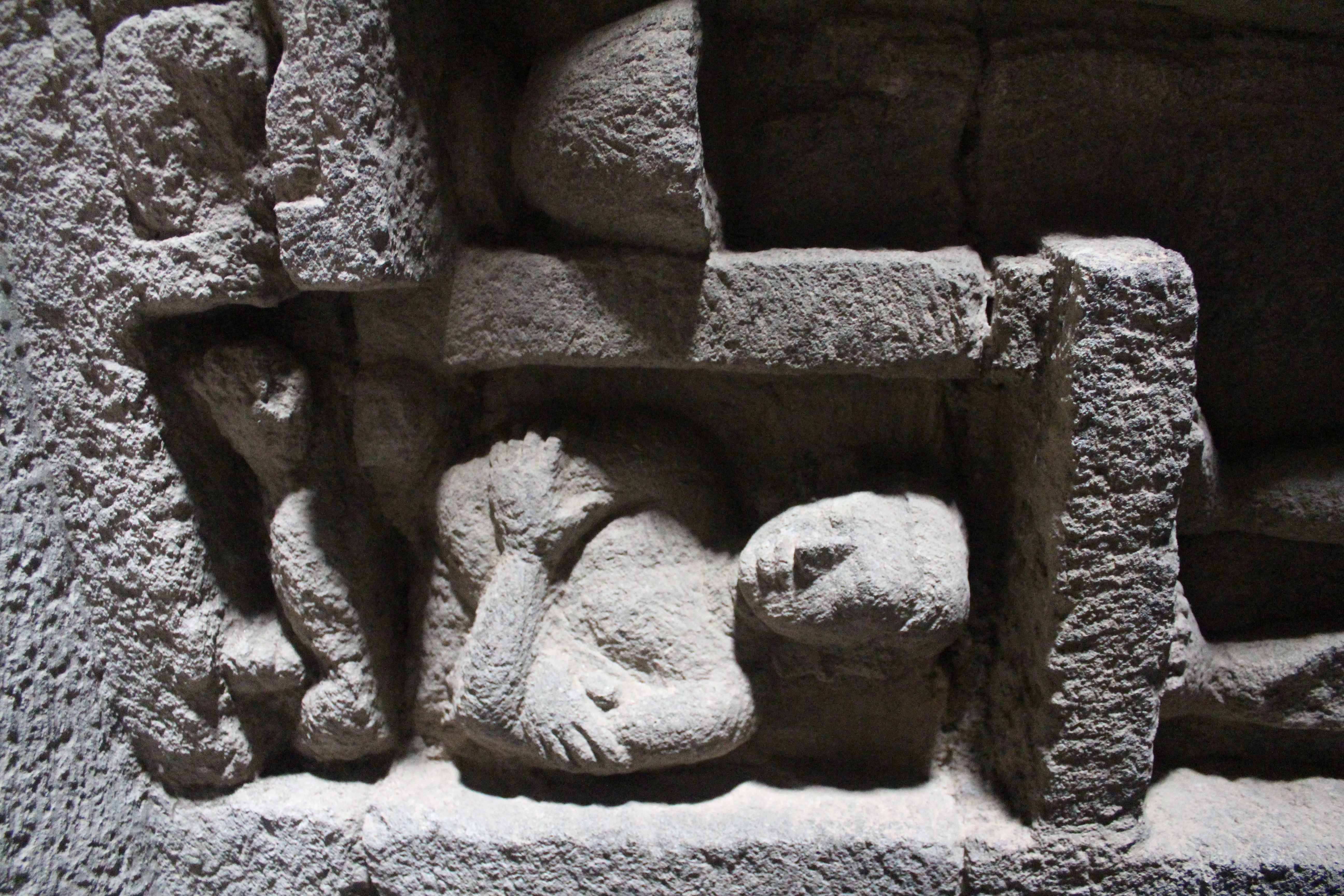 Relief showing a crouching devotee with crossed arms