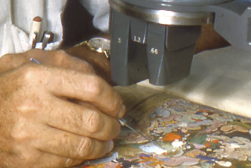 a conservator works on a mughal painting