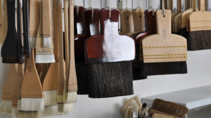 Different sized brushes hanging