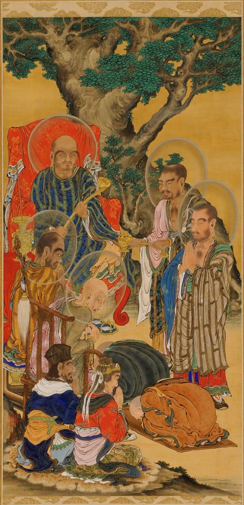Two boys with newly shorn heads bow down before a group of rakan.