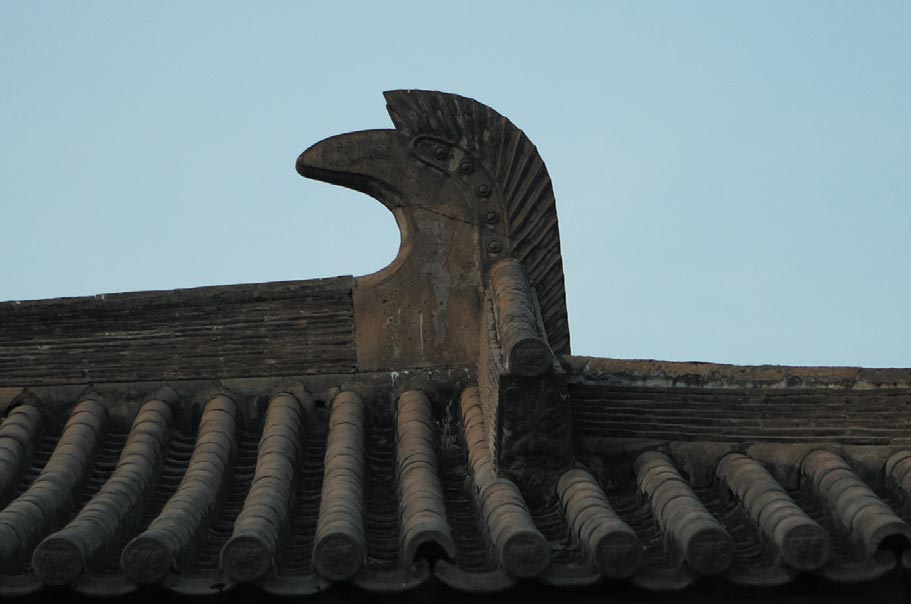 close detail of a roof showing curved ornament