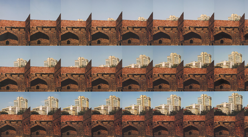 Twenty-seven photographs are arranged in a nine-by-three grid. In the background of each image is a blue sky, and in the foreground of each image is an old red brick wall. Read left to right, the images convey a narrative sequence. On the horizon line, cream-colored modern high-rise buildings appear to emerge upward step-by-step from behind the red brick.